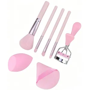 Pink makeup brush set with eyelash curler beauty blender and powder puff for daily use.