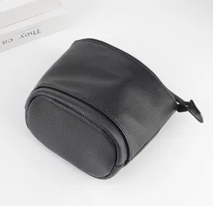 Portable black PU leather cosmetic bag with fine texture, durable telescopic storage pouch.