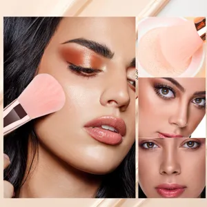 Detail view of soft pink makeup brush set and cosmetic puff for flawless face application.