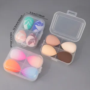 Detail view of clear plastic storage boxes with assorted color beauty makeup sponges inside.