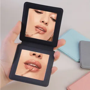 Compact double-sided folding cosmetic mirror for daily makeup and portable desktop use.