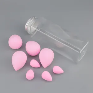 Detailed view of assorted pink makeup sponges in different shapes with a clear storage jar.