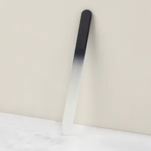 Crystal glass nail file detail view, gradient sandblasted manicure tool finish close up.