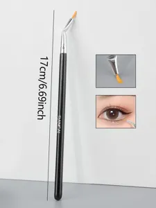 Detail shot of angled eyeliner brush tip and eye makeup application effect clearly.