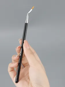 Angled eyeliner detail makeup brush close-up showing precision bent tip and black handle.