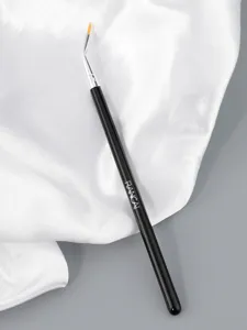 Angled eyeliner brush with fine tip and ergonomic black handle for precise eye makeup details.