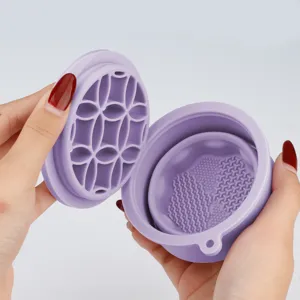 Detail view of the collapsible purple silicone makeup brush cleaner cup with textured inner base.