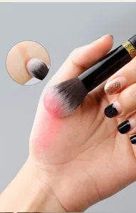 Professional gradient makeup brush for smooth blush and contour application details closeup.