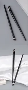 Professional angled concealer brush and highlight brush set with sleek black handles for precision makeup.