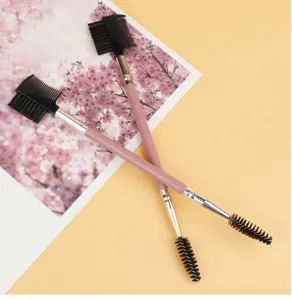 Pincel de cejas de doble punta y cepillo de pestañas herramienta de maquillaje rosa para estilizar.