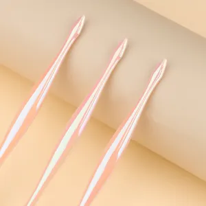 Close-up detail of three pink iridescent nail art liner brushes with glossy finish.