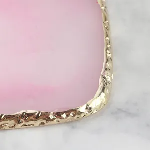 Pink resin nail art palette detail, gold edge cosmetic mixing tray, manicure tool close up