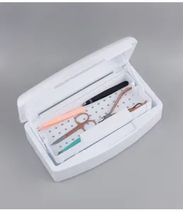 Professional nail tool disinfection box with draining tray and cleaning instruments for salon use.