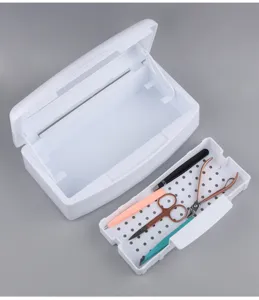 Detail shot showing the white nail tool sterilization box and internal draining tray with tools.