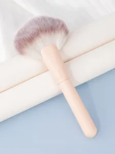 Large fan makeup brush detail view, soft synthetic bristles for highlighter and setting powder application.