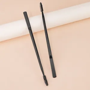 Professional double-ended eyebrow brush and spoolie tool for precise makeup application.