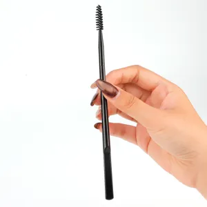Detail view of black dual-headed eyebrow brush and spoolie for precise makeup application.