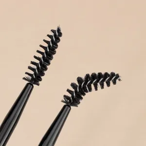 Close-up of double-headed spiral eyebrow brush with bendable heads and black handle.