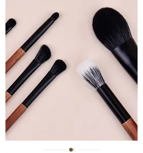 Portable mini makeup brush set with wooden handle and soft bristles for travel use.