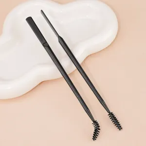 Detail view of black double-ended eyebrow brush with bendable spoolie and spatula for makeup.