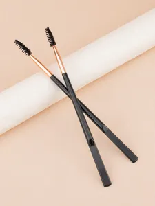 Dual-ended eyebrow brush and spoolie makeup tool with ergonomic black handle for precise application.