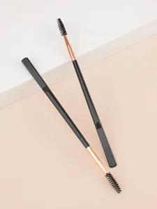 Double-ended eyebrow brush and spoolie for precise makeup application and grooming.