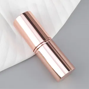 Retractable cosmetic brush handle in rose gold metal finish, portable makeup tool case.