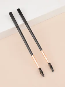 Detail shot of dual ended eyebrow spoolie brush with black handle and rose gold ferrule.