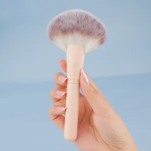 Large fan makeup brush for face setting, loose powder, and highlighter with beige handle main view.