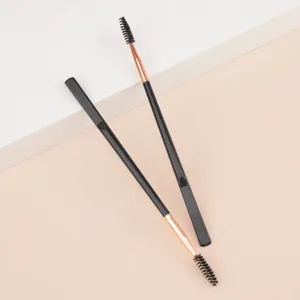 Dual-ended eyebrow brush and eyelash spoolie tool with sleek black and rose gold design.
