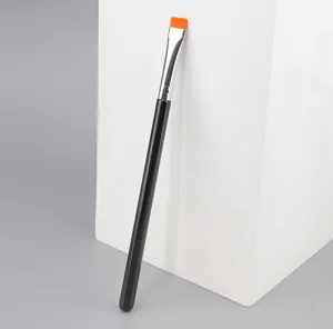 Vista detallada del pincel de maquillaje plano con mango negro y cerdas naranjas.