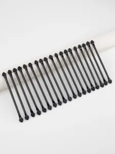 Detail view of dual-ended sponge eyeshadow brushes, black handles, professional makeup tool.