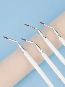 Close-up detail of angled eyeliner brushes with soft brown bristles and white handles.