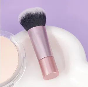 Portable short handle makeup brush for loose powder and blush, sleek pink design tool.