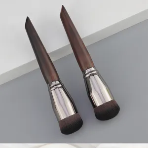 Detailed shot of professional round foundation brushes with smooth wood handles and dense bristles.