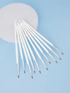 Set of fine detail brushes with white handles, professional art and eyeliner makeup tools.