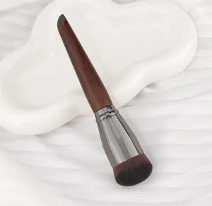Professional round foundation brush with dense bristles for seamless makeup application.