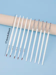 Detailed close-up view of fine white handle makeup detail brushes with brown bristles on prop.