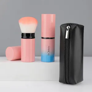 Portable retractable makeup brush set with gradient pink design and black PU storage bag.