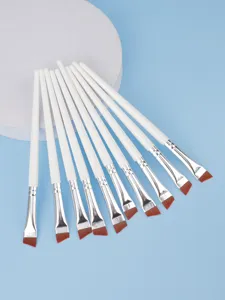 Detail view of professional angled eyeliner brush set with soft synthetic hair and white handles.