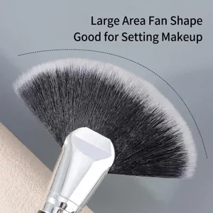 Large fan makeup brush with soft synthetic fibers for professional highlighting and setting powder.
