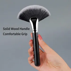 Large wooden handle fan makeup brush with soft synthetic bristles for highlighter and powder.