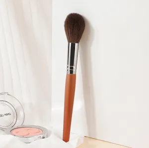 Soft synthetic makeup blush brush with wooden handle for precise powder and highlighter.