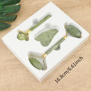 Jade roller and gua sha set detail view, facial massage tool in gift box, smooth green stone.