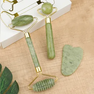 Jade roller and gua sha facial massager set detail view featuring smooth green stone tools.