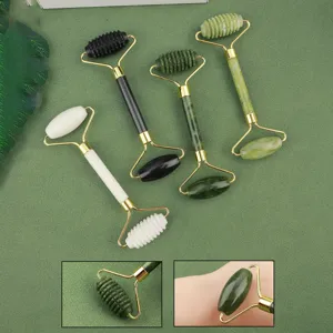 Detail view of multi-color jade facial roller massager with gold metal frame for skincare.