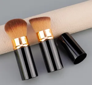 Close-up detail of portable retractable makeup brush featuring soft brown synthetic bristles.