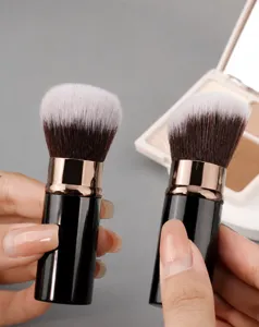 Detailed view of bicolored soft makeup brushes including round powder and angled contour brushes.
