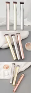 Detailed view of slanted makeup brushes featuring metal handles and soft bristles in trendy colors.