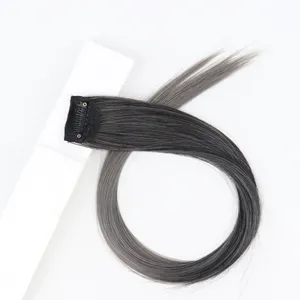 Detailed view of grey gradient clip-in hair extension piece with secure black clip for styling.